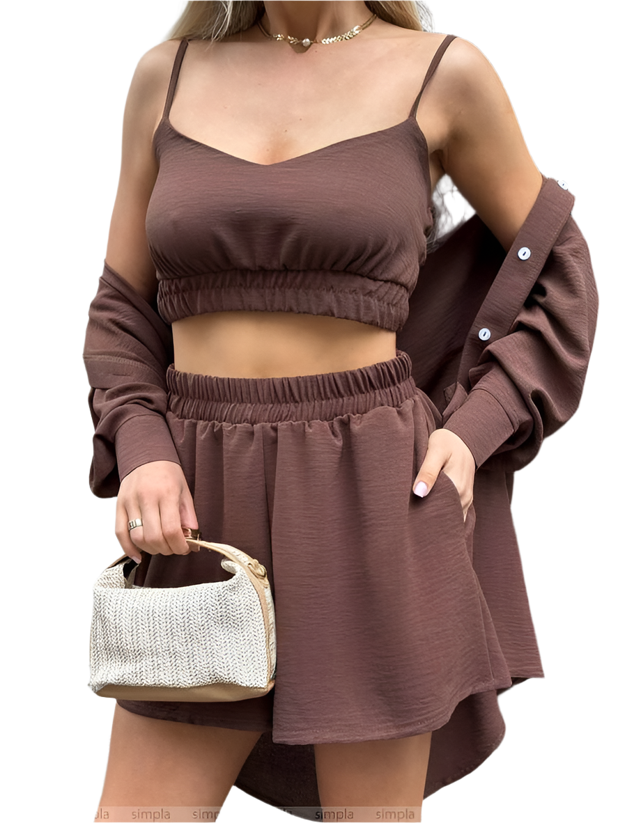 Woman wearing a brown outfit with a matching bag on a white background