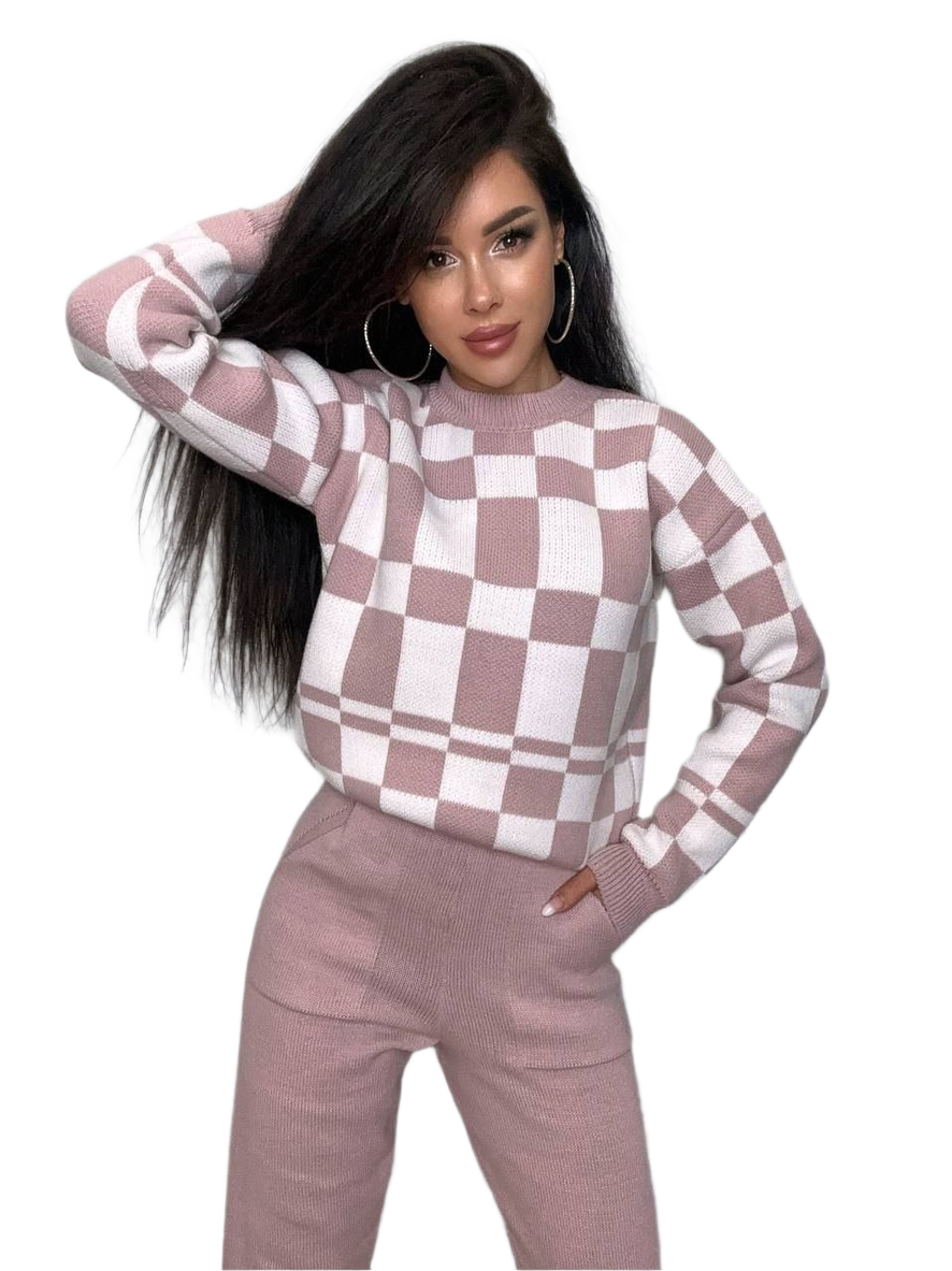 Woman wearing a checkered sweater and pants on a white background