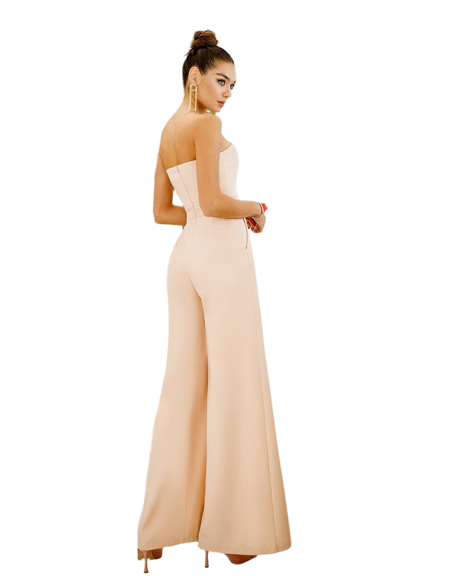 Woman wearing a strapless beige jumpsuit on a white background