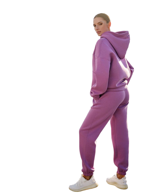 Person wearing a pink tracksuit on a white background