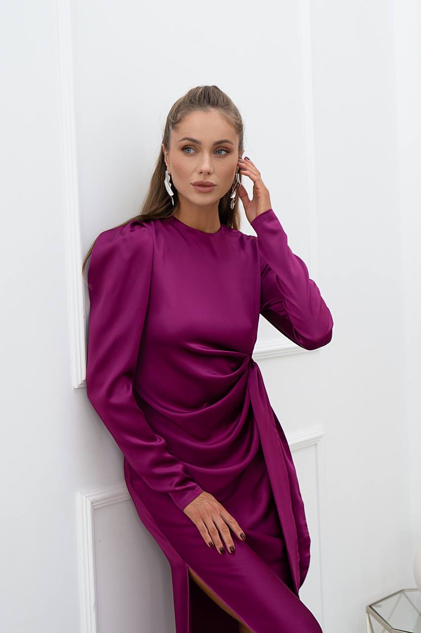 Woman wearing a purple dress against a white background