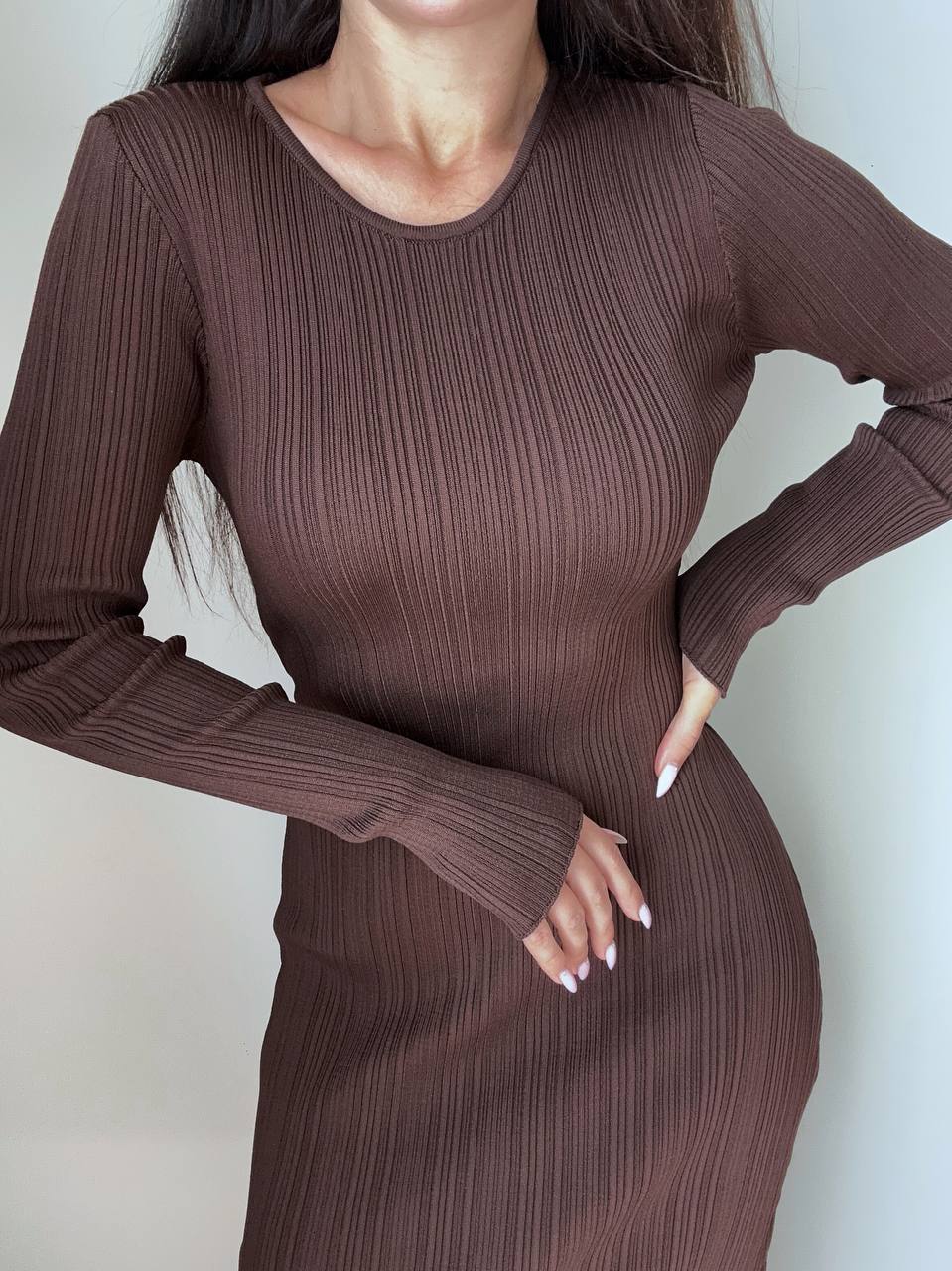 Brown ribbed dress worn by a person on a plain background