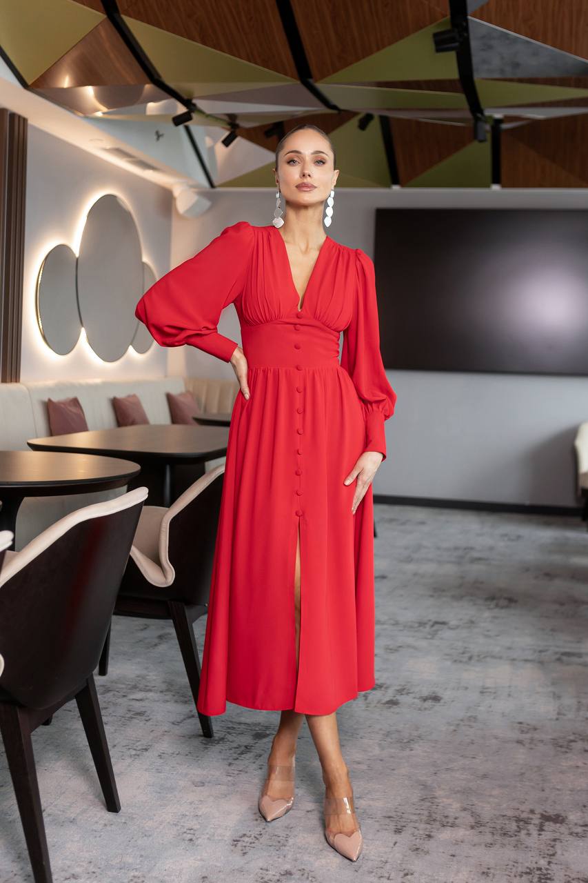 Woman in a red dress standing in a modern restaurant setting