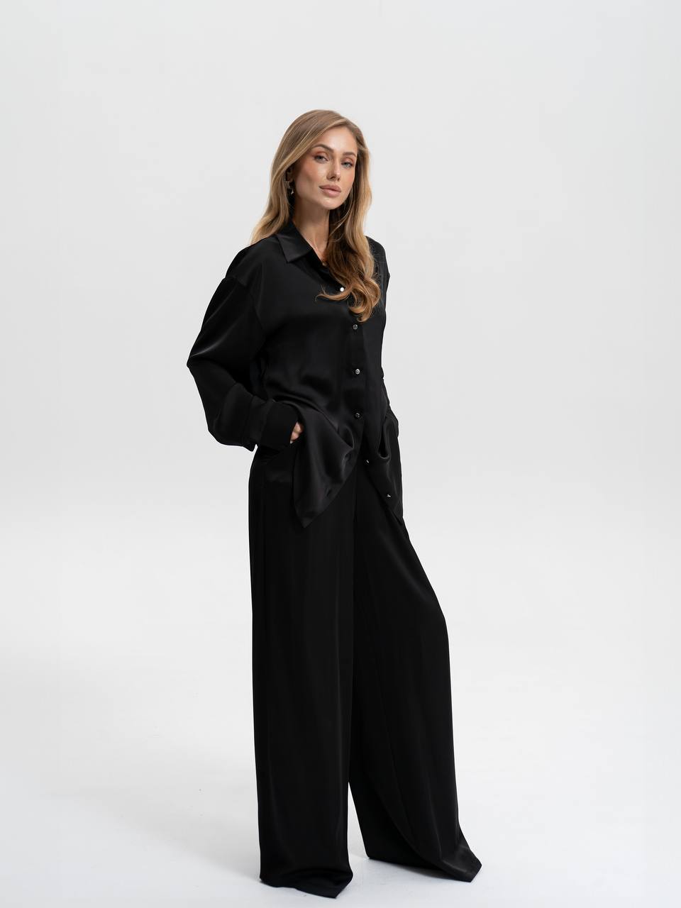 Woman wearing a black outfit on a white background