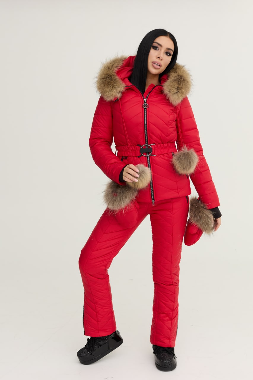 Person wearing a red puffer suit with fur trim on a white background