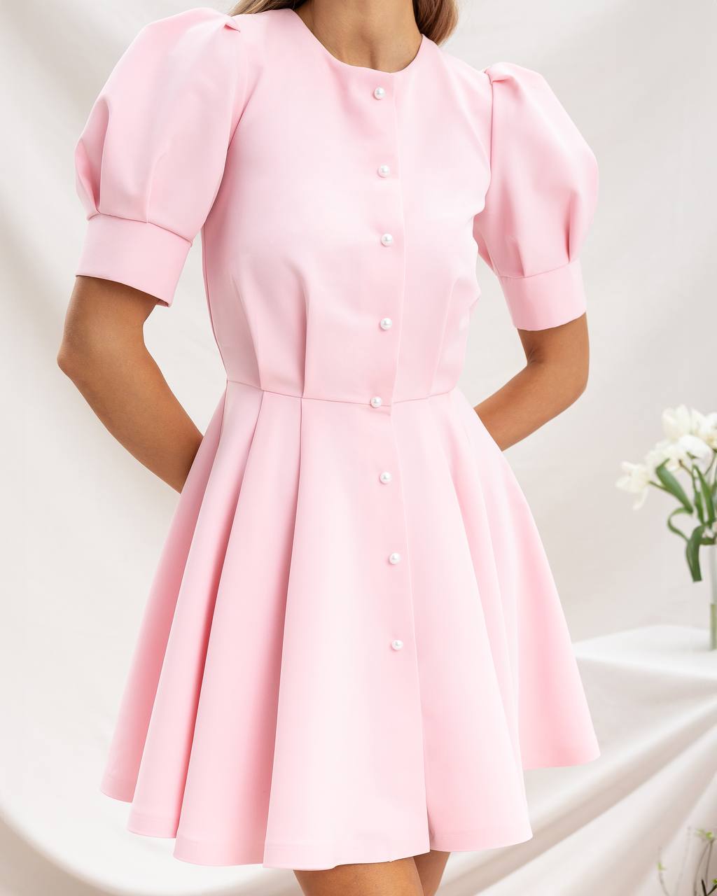 Pink dress with puff sleeves on a white background
