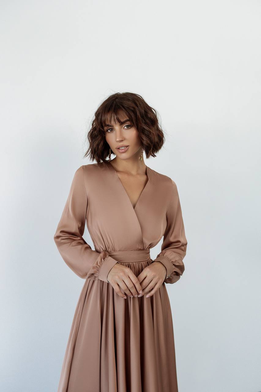 Woman wearing a brown dress against a white background
