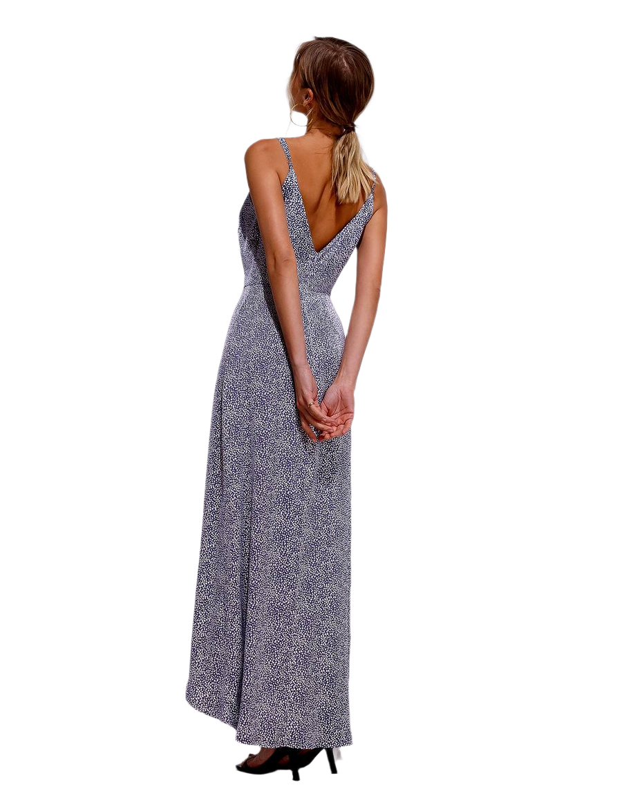 Woman wearing a long, patterned dress on a white background