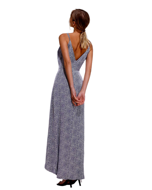 Woman wearing a long, patterned dress on a white background