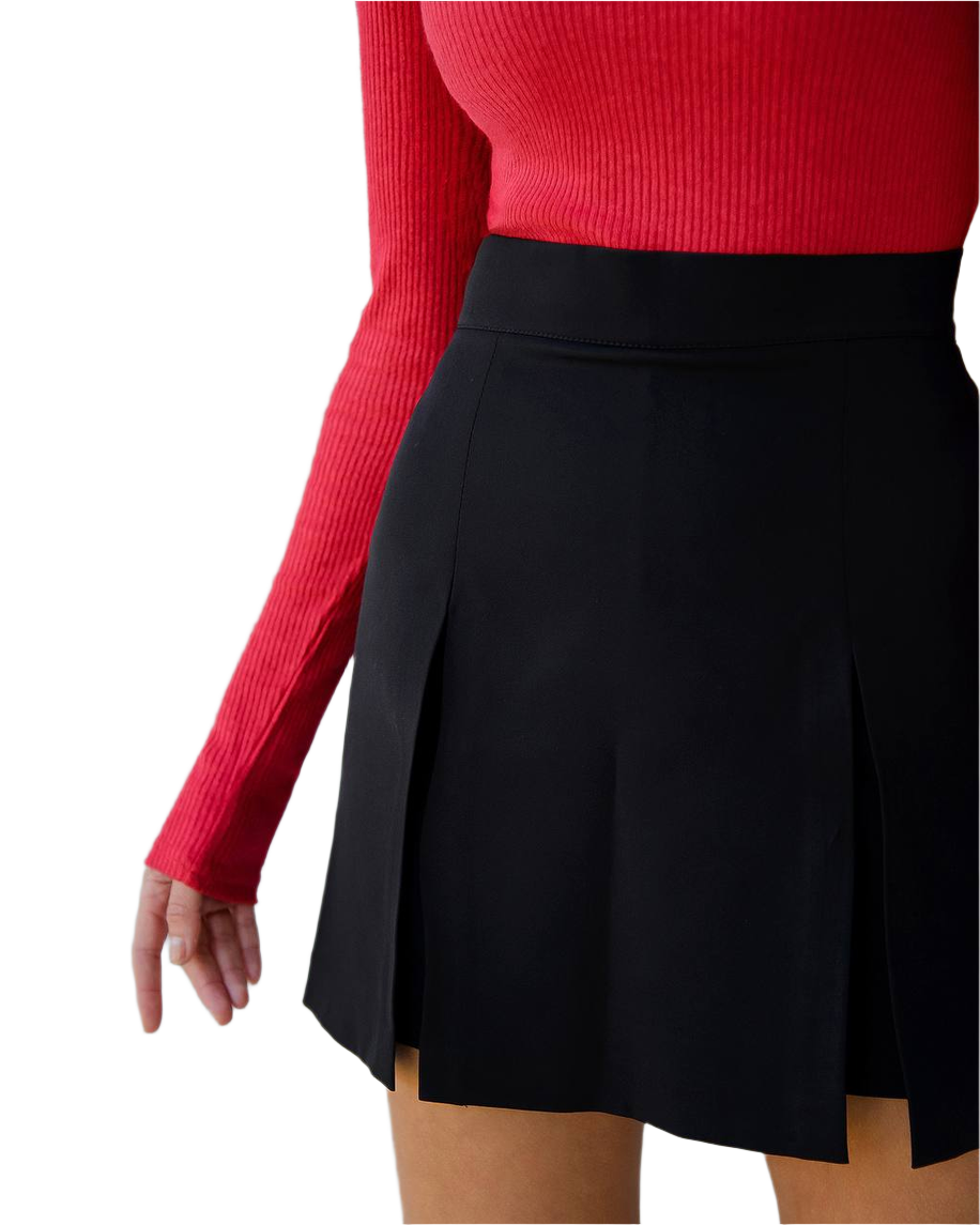 Person wearing a red long-sleeve top and black skirt on a white background