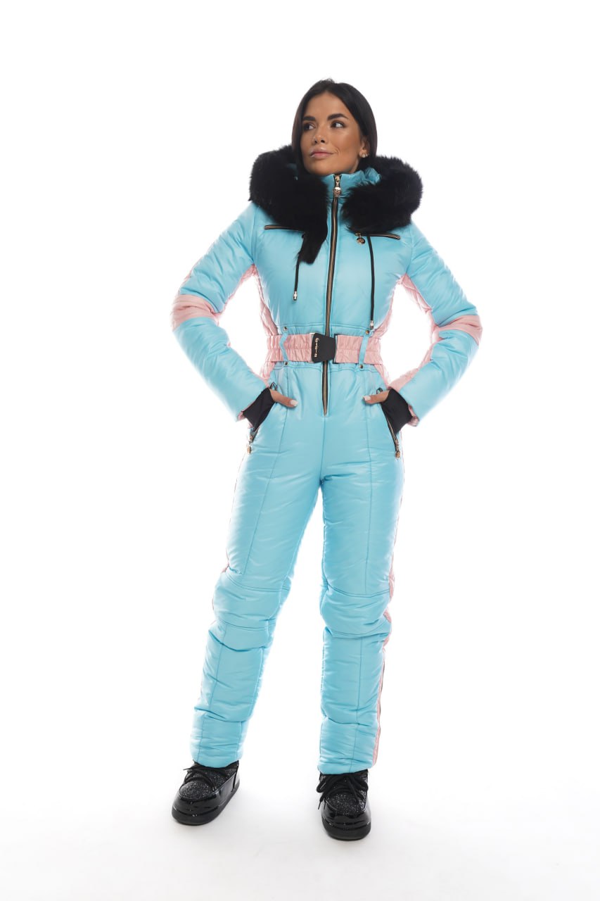 Woman wearing a light blue snowsuit with black fur trim on a white background