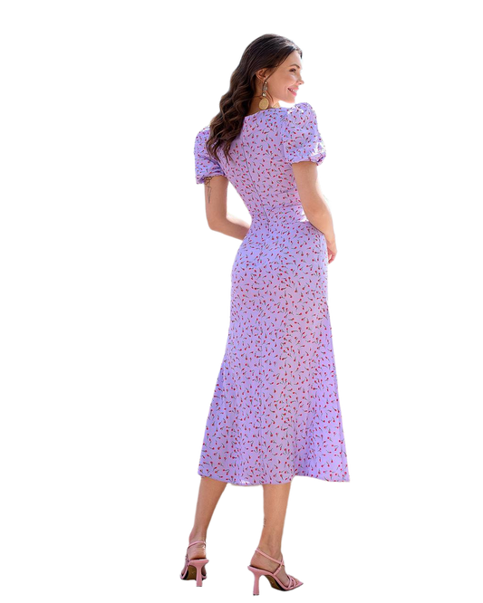 Woman wearing a purple floral dress on a white background