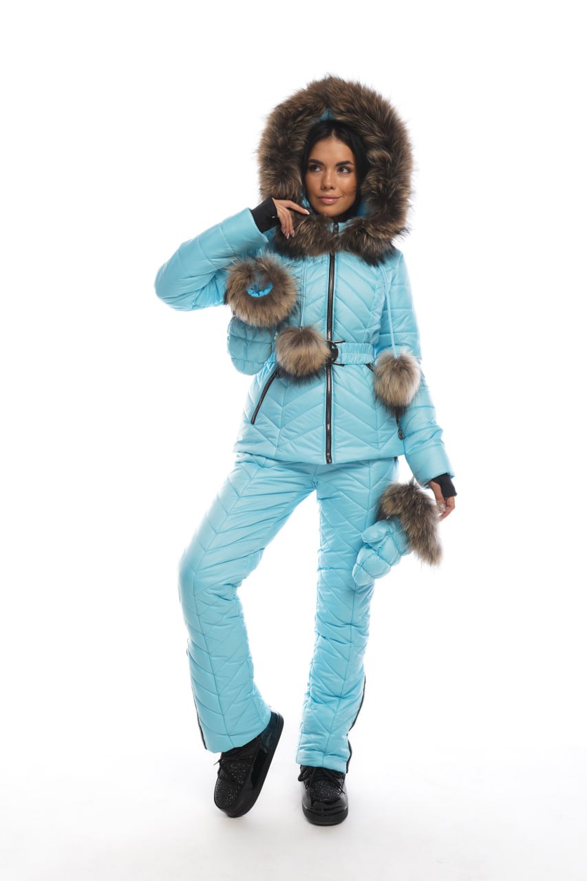 Person wearing a light blue winter suit with fur trim on a white background