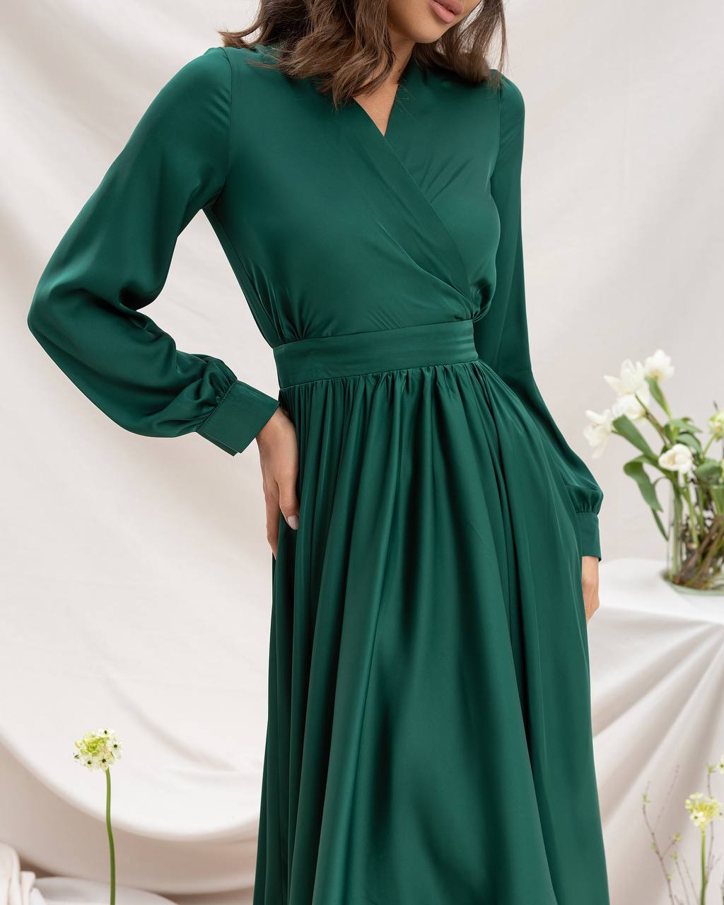 Green dress worn by a person on a neutral background