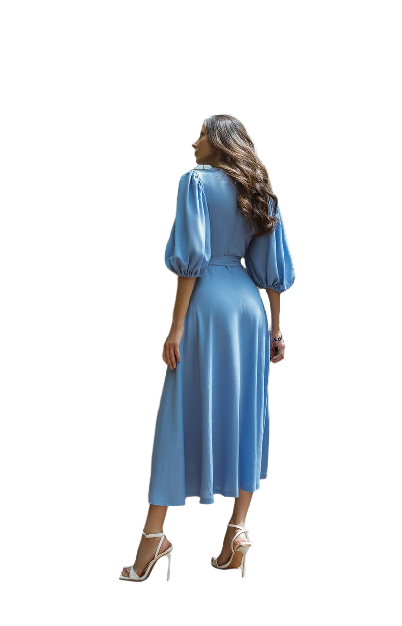 Woman wearing a blue dress with long sleeves on a white background