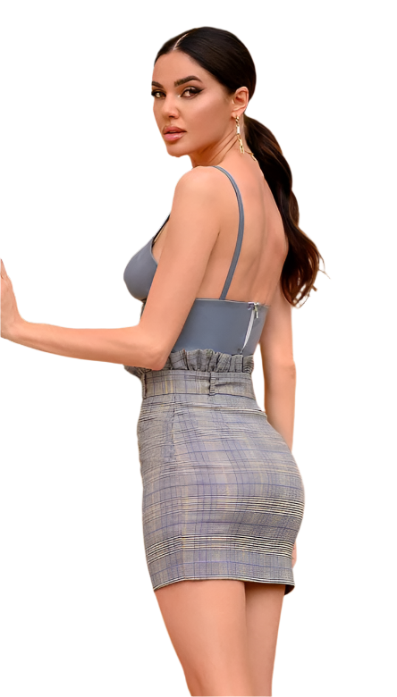 Woman wearing a gray dress with a plaid pattern on a white background