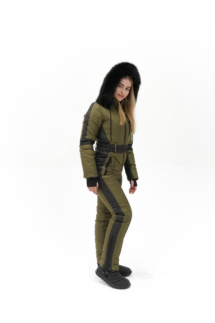 Person wearing a green and black futuristic outfit on a white background