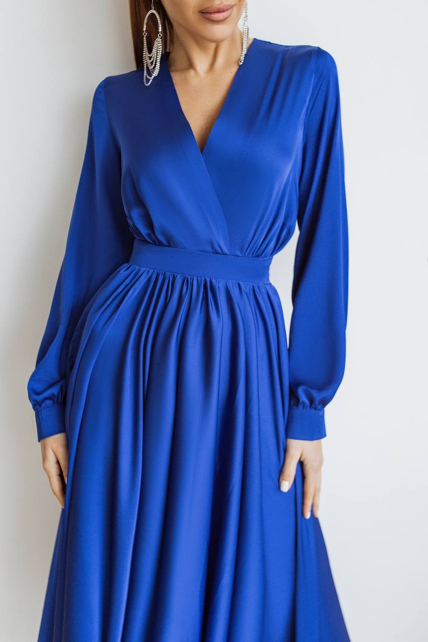 Blue dress worn by a model on a white background