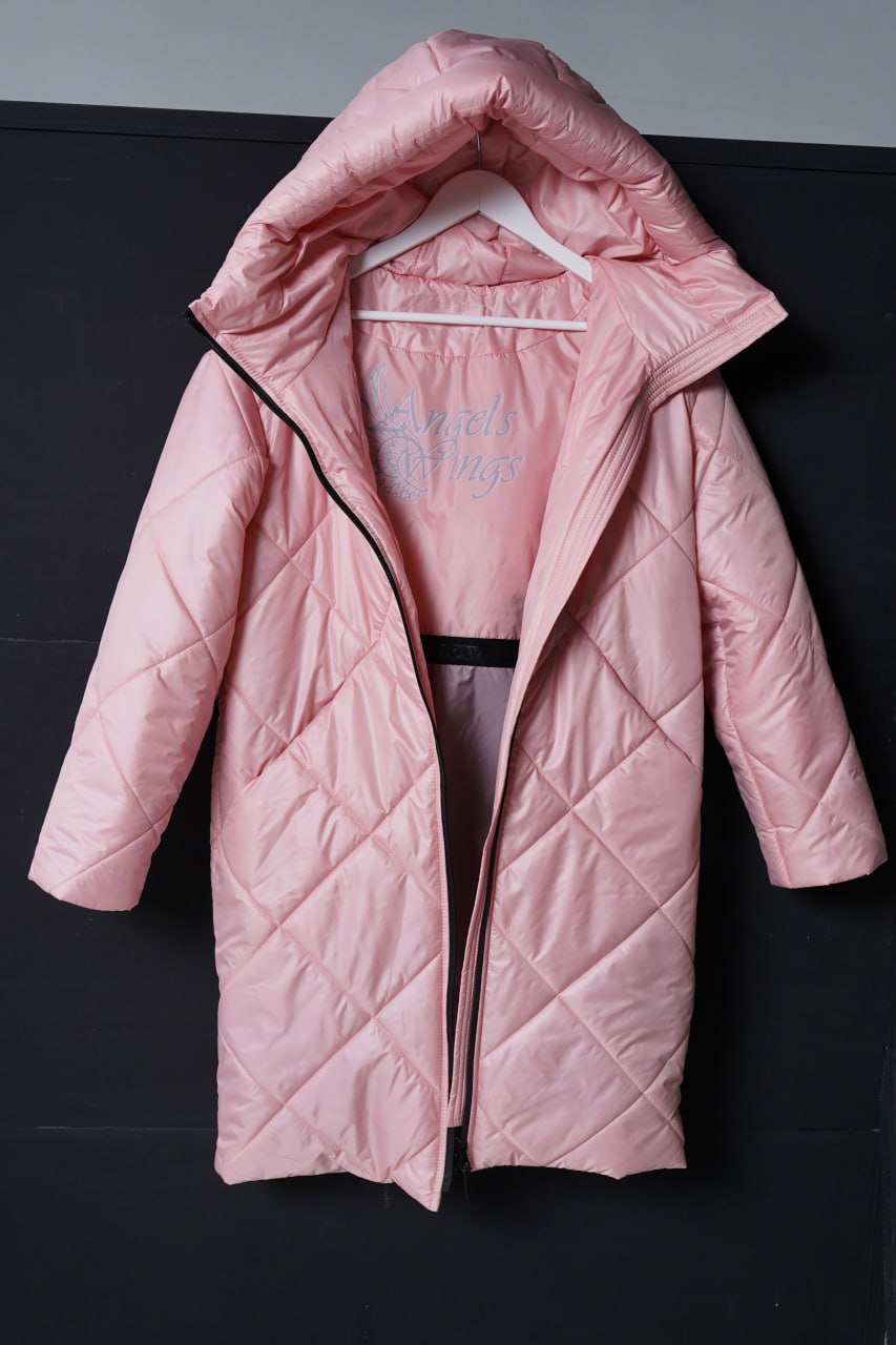 Pink quilted coat on a hanger against a dark background
