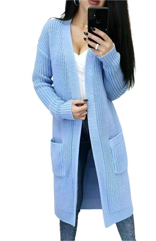 Person wearing a light blue cardigan with pockets on a white background