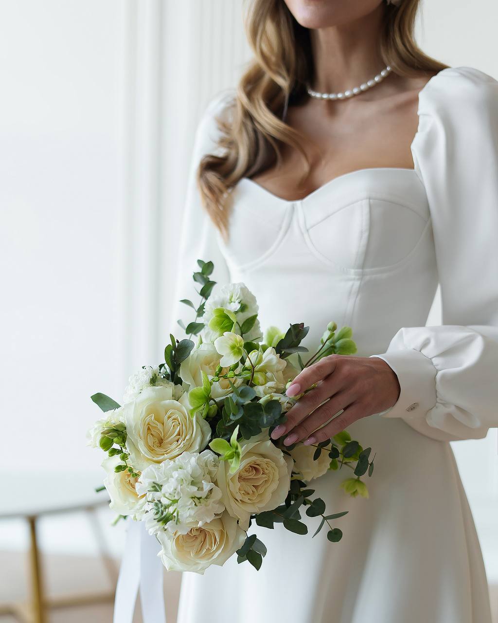 Bride holding a bouquet of flowers in a softly lit room