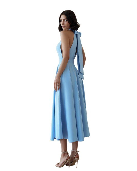 Woman wearing a light blue dress with a plunging neckline and shoulder straps on a white background