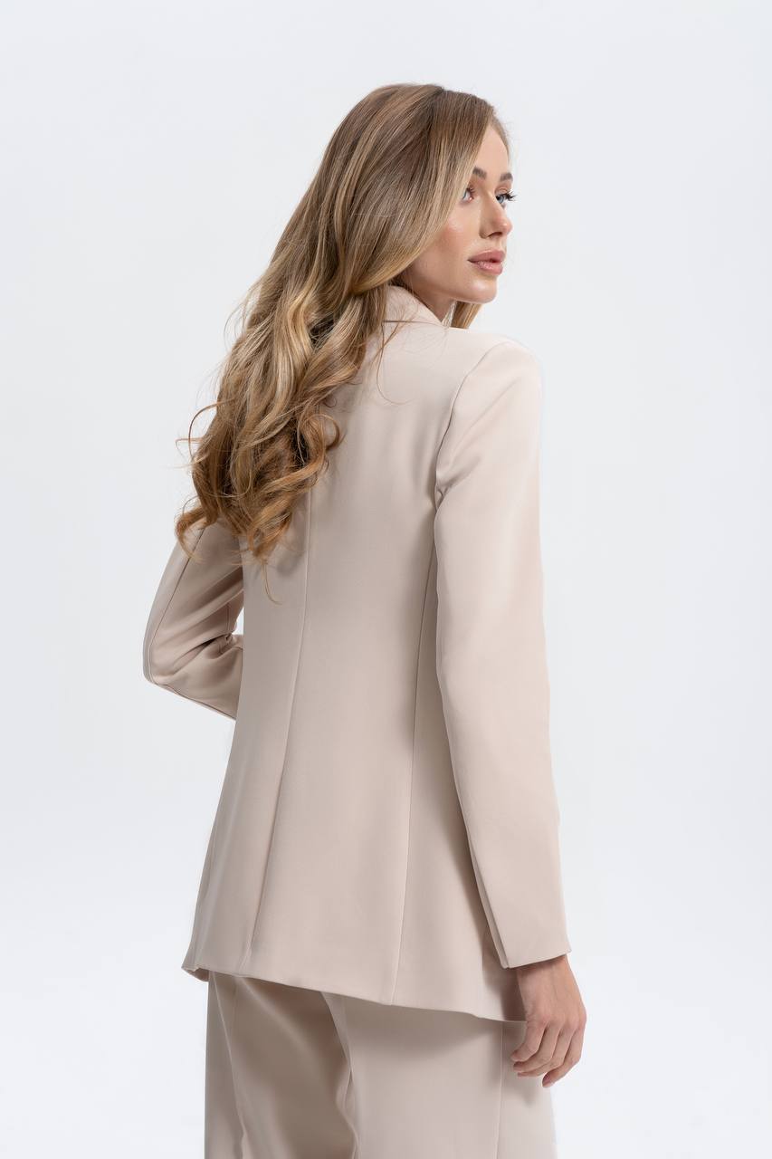 Woman wearing a beige suit on a white background