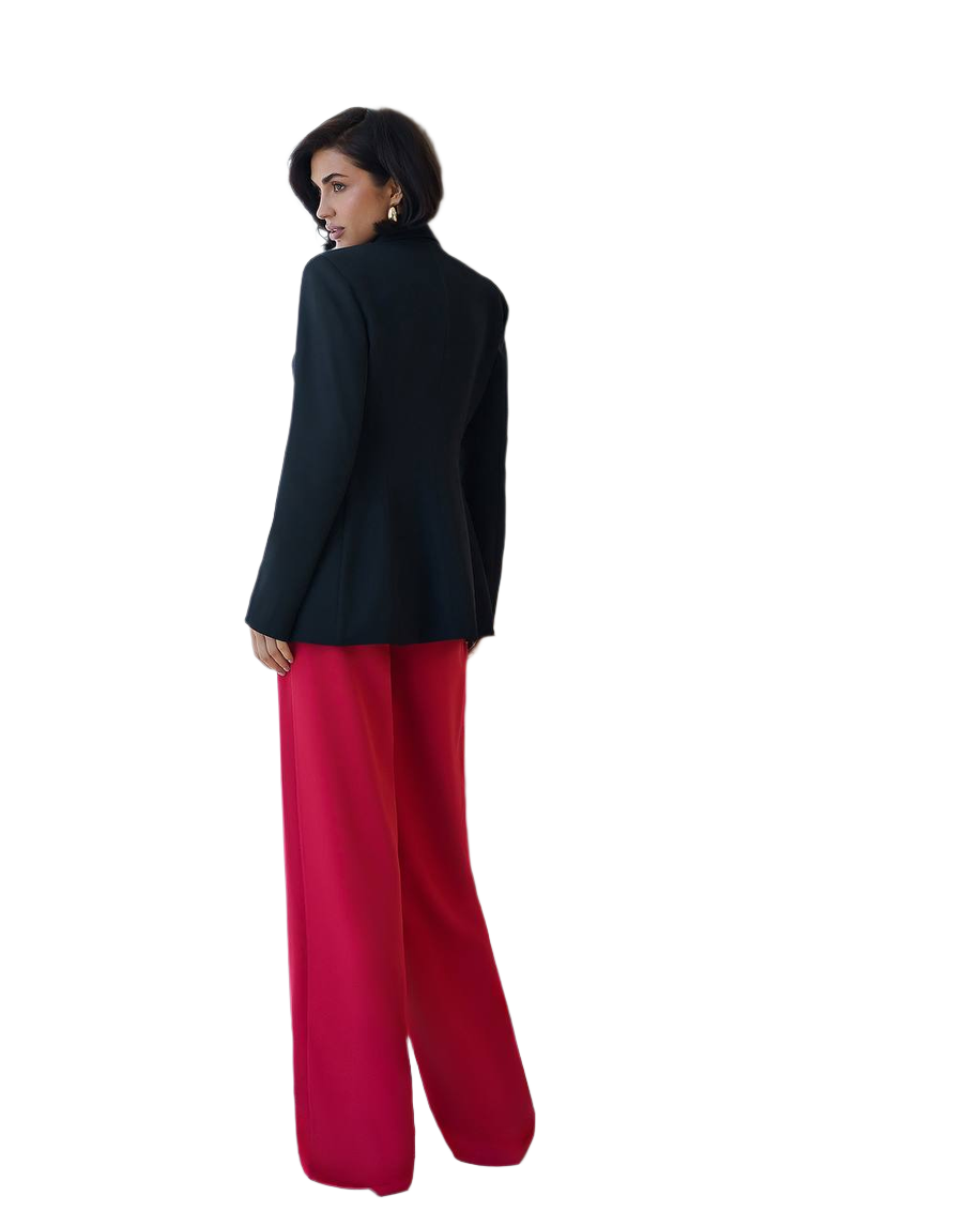 Woman wearing a black jacket and red pants on a white background