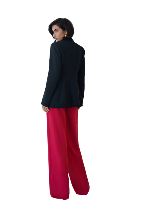 Woman wearing a black jacket and red pants on a white background