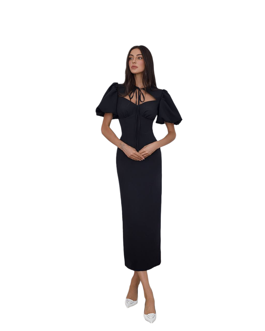 Woman wearing a black dress with puff sleeves on a white background