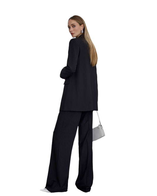 Woman wearing a black pinstripe suit with a white background
