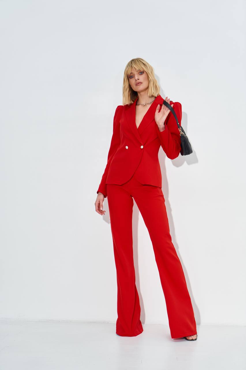 Woman wearing a red suit on a white background