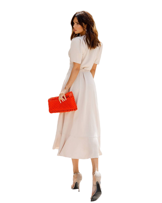 Woman in a white dress holding a red clutch on a white background