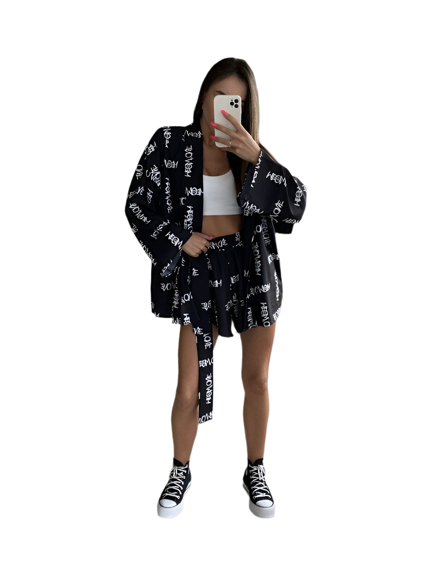 Person wearing a black and white patterned outfit with a white background