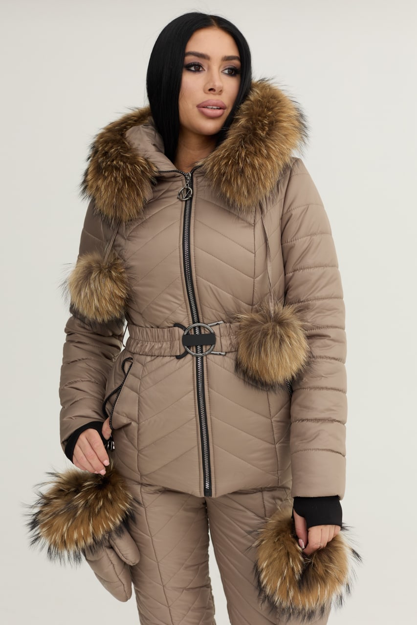 Woman wearing a beige puffer jacket with fur trim on a white background