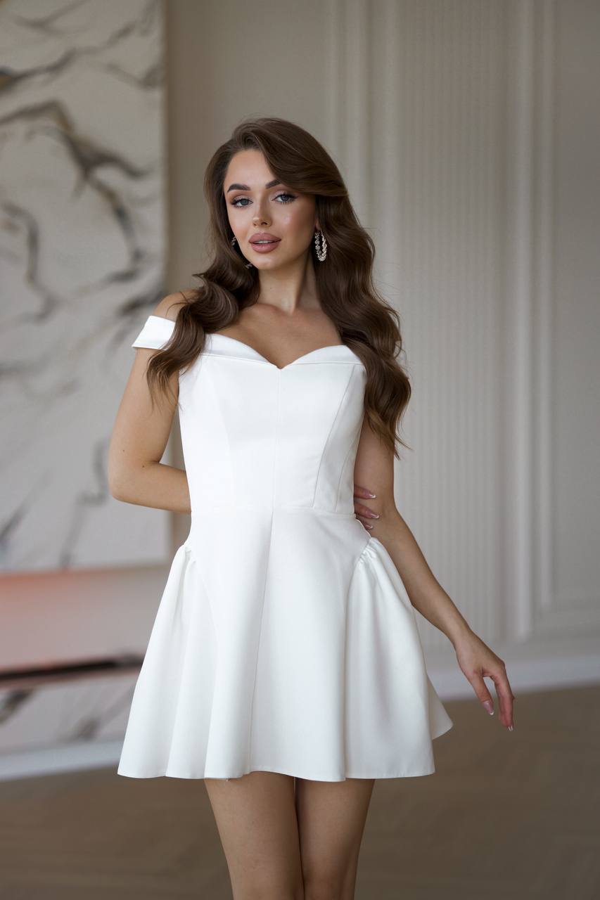 Woman wearing a white dress in an indoor setting