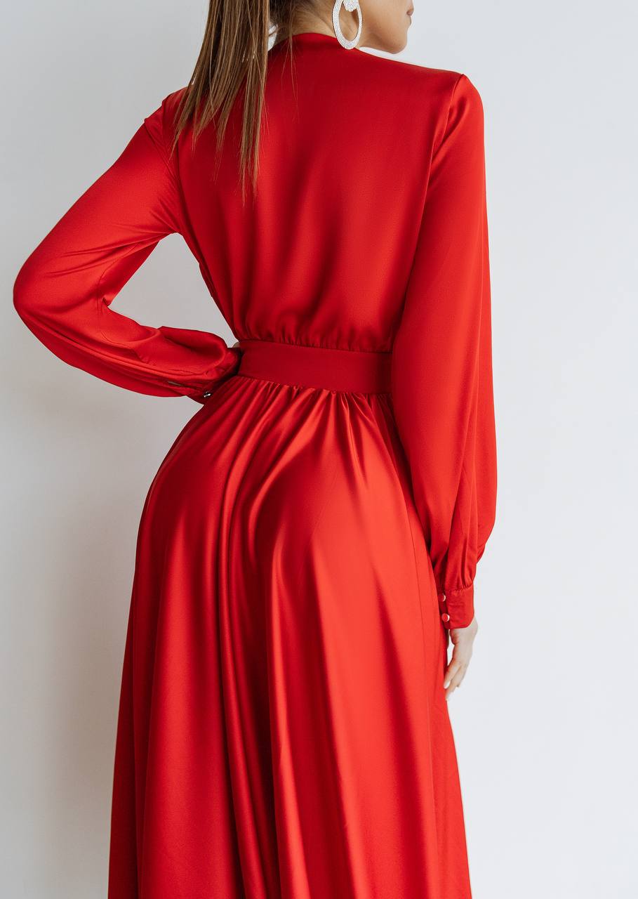 Red dress with long sleeves on a plain background