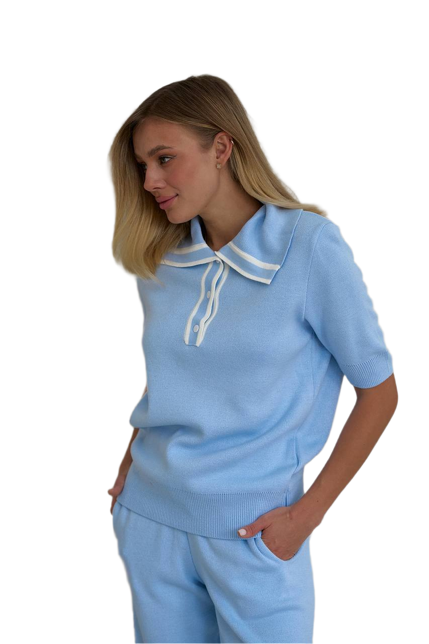 Woman wearing a light blue outfit with a white collar on a white background
