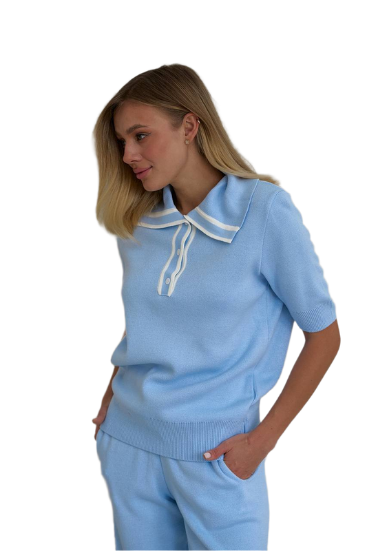 Woman wearing a light blue outfit with a white collar on a white background
