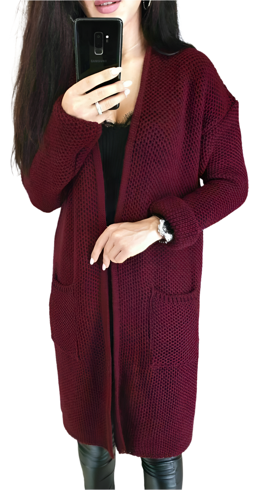 Person wearing a burgundy knitted cardigan on a white background