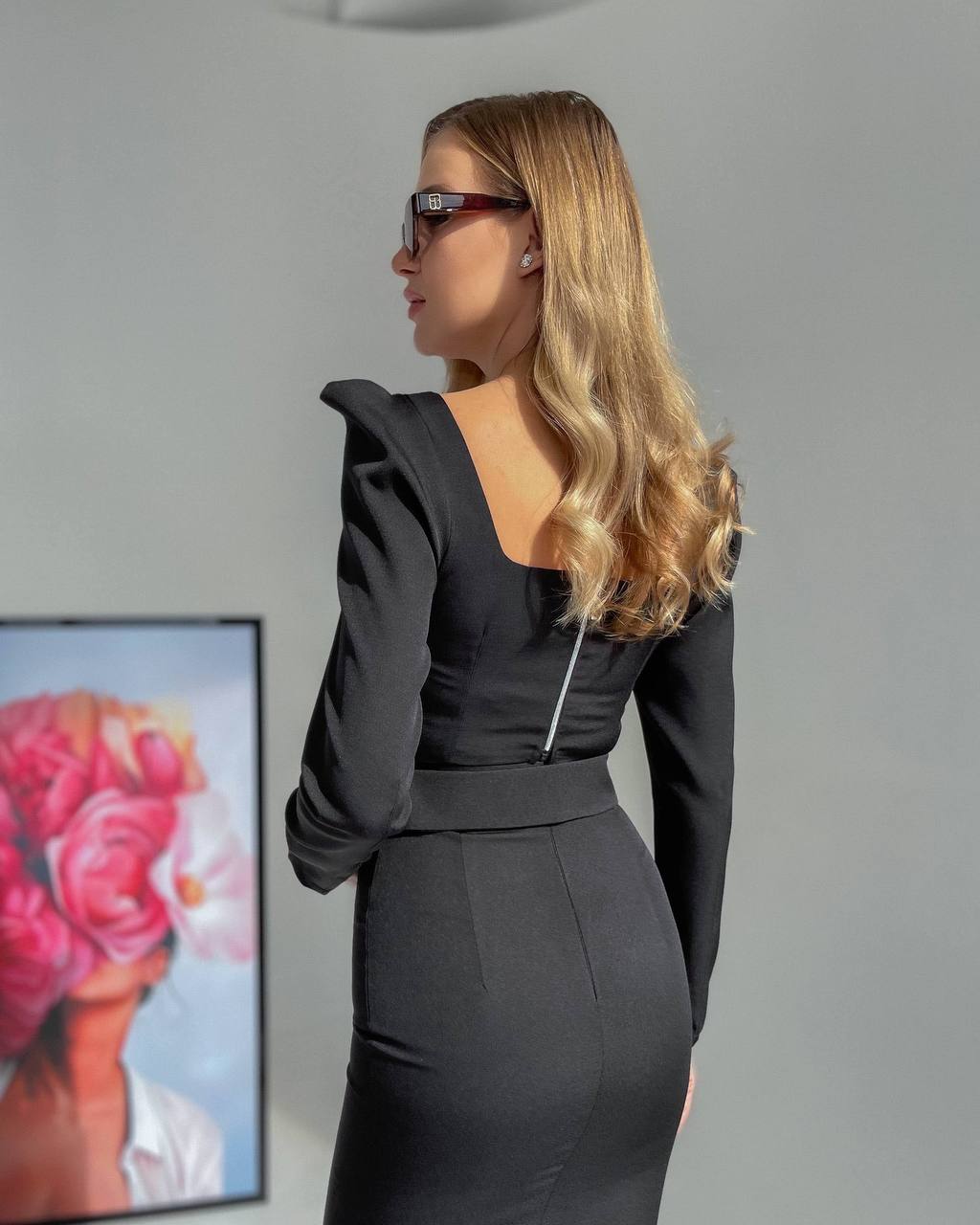 Woman wearing a black dress with a blurred background