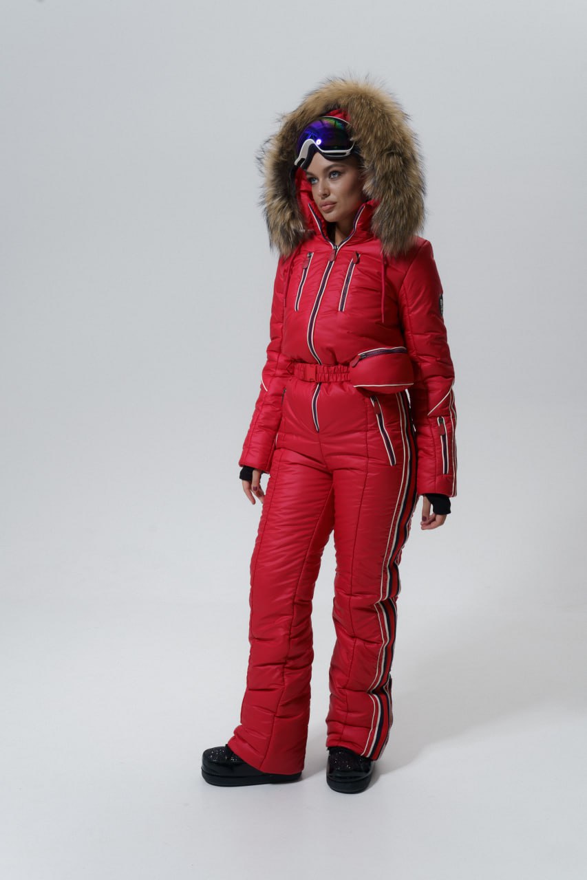 Person wearing a red snowsuit with a fur-lined hood on a white background