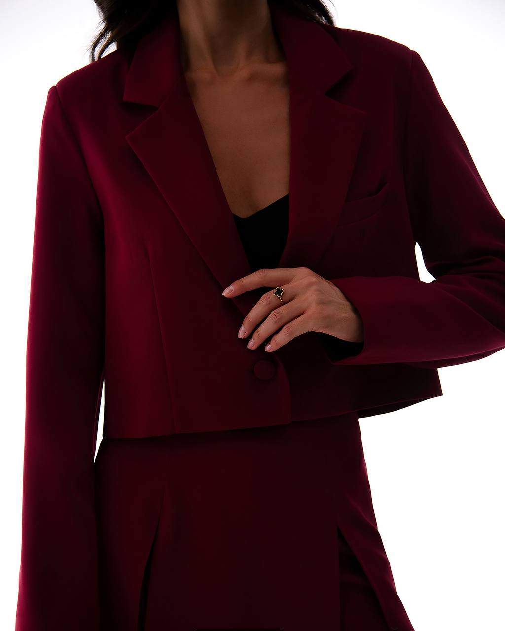 Burgundy suit worn by a person on a white background