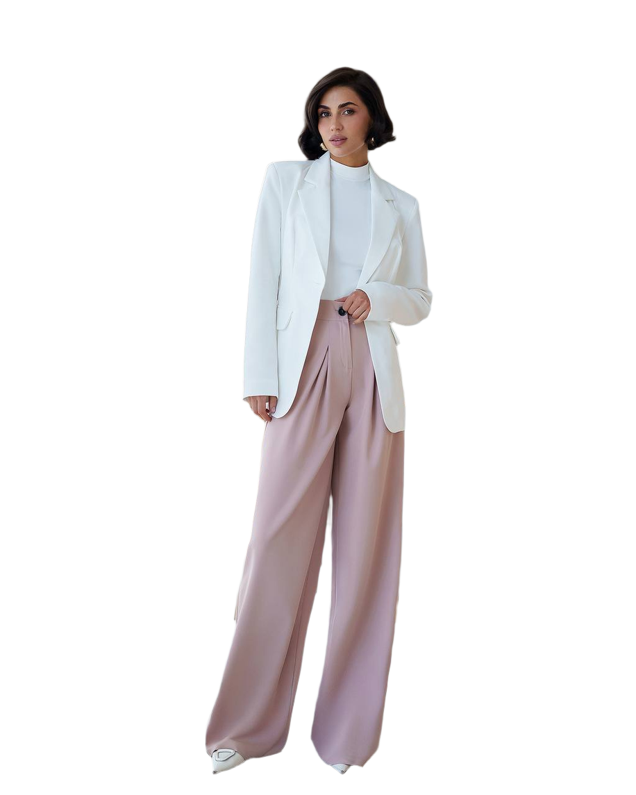 Woman wearing a white blazer and pink pants on a white background