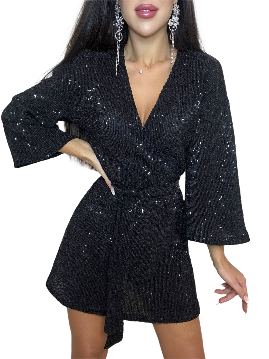 Black sequin dress worn by a model on a white background