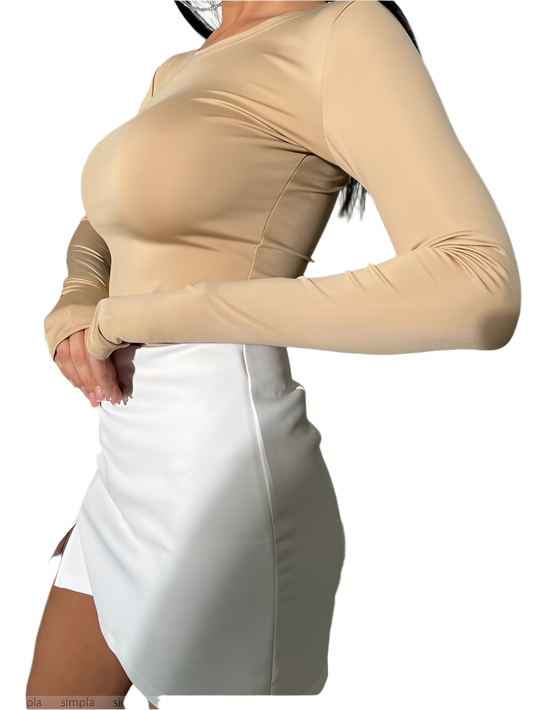 Beige long-sleeve top worn by a person on a white background