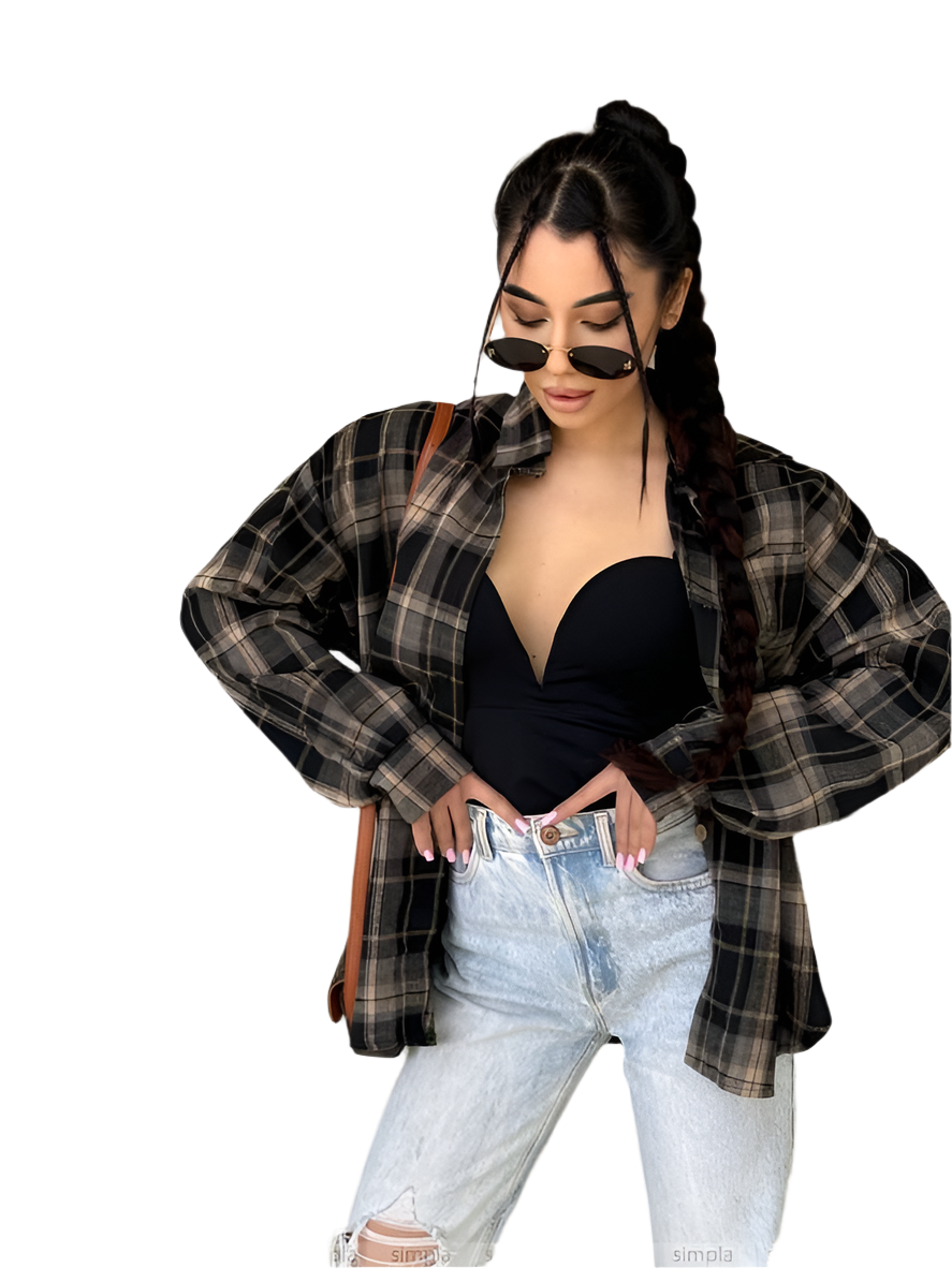 Woman wearing a plaid shirt, black top, and light blue jeans on a white background