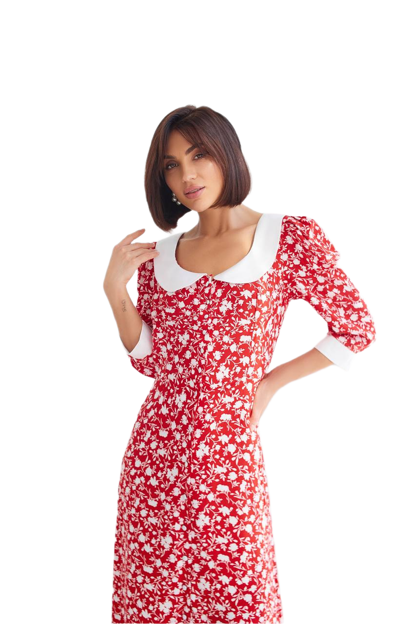 Woman wearing a red floral dress with white accents on a white background