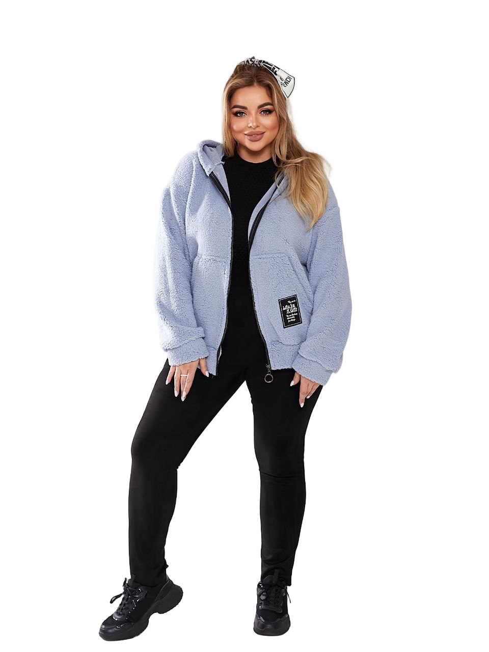 Woman wearing a light blue jacket with a brand logo on a white background