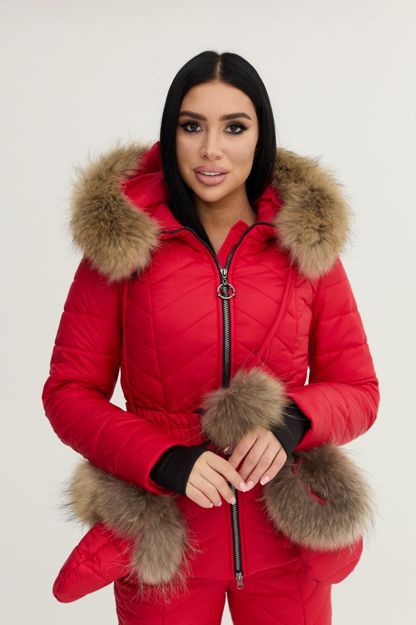 Person wearing a red puffer jacket with fur trim on a white background
